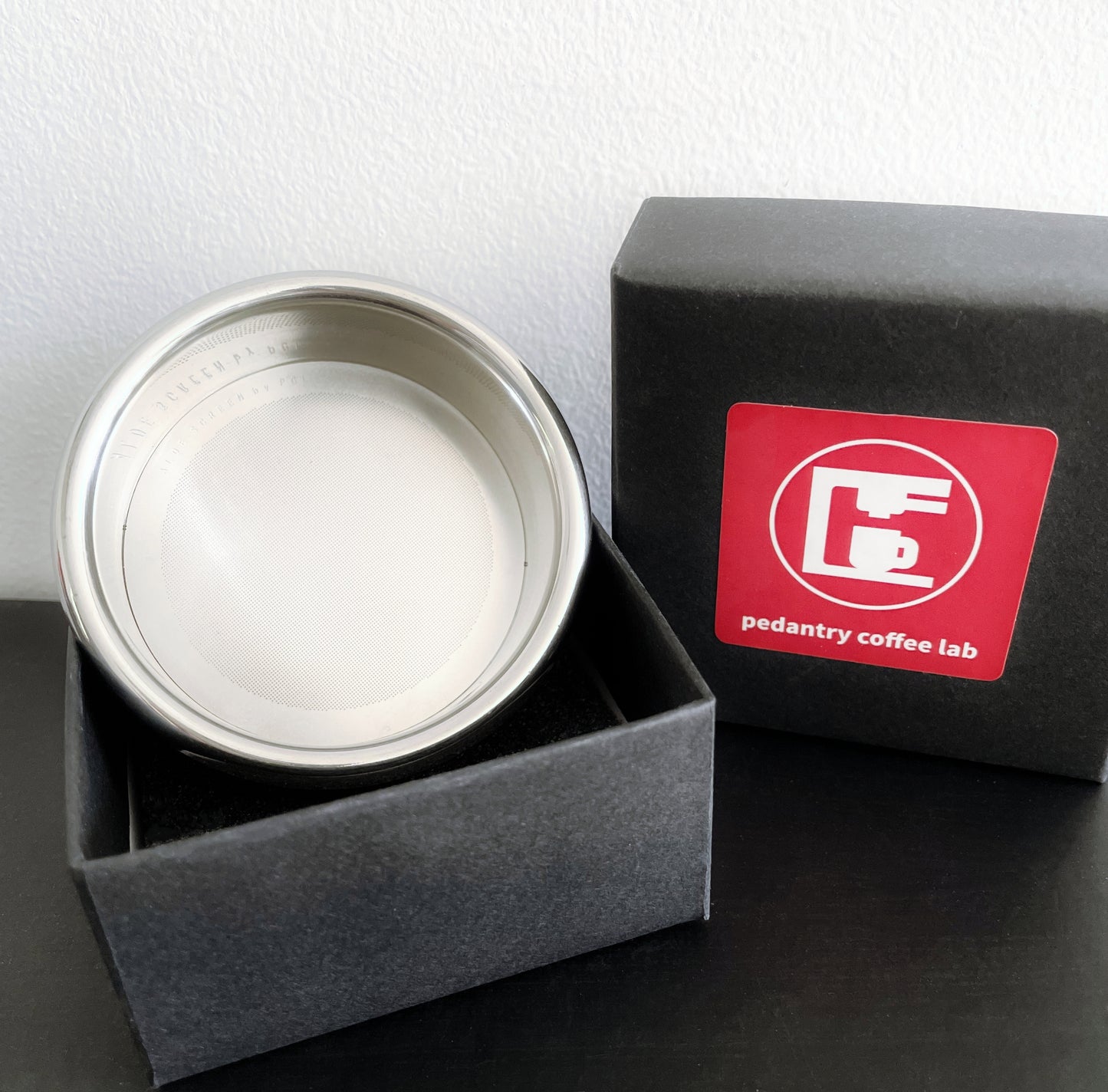 PCL 58mm filter basket beside espresso accessories