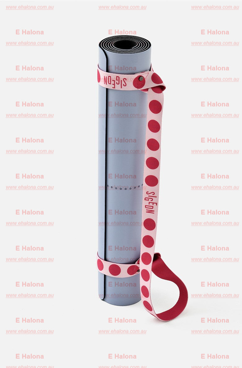 Yoga strap used to carry a rolled yoga mat